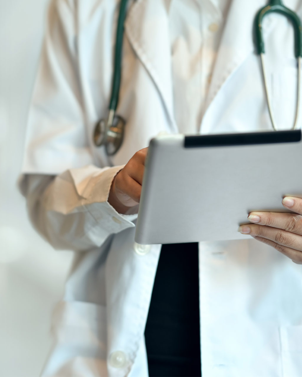 Arzt im weißen Kittel mit Stethoskop hält ein Tablet – unzugängliche Patientenportale und digitale Terminbuchung als Barrierefreiheits-Problem für Kliniken und Gesundheitsdienstleister nach BFSG und WCAG 2.2
