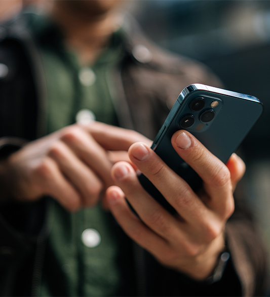 Nahaufnahme einer Hand, die ein Smartphone bedient – barrierefreie Tarif-Konfiguratoren und digitale Kundenportale für Mobilfunkanbieter nach BFSG